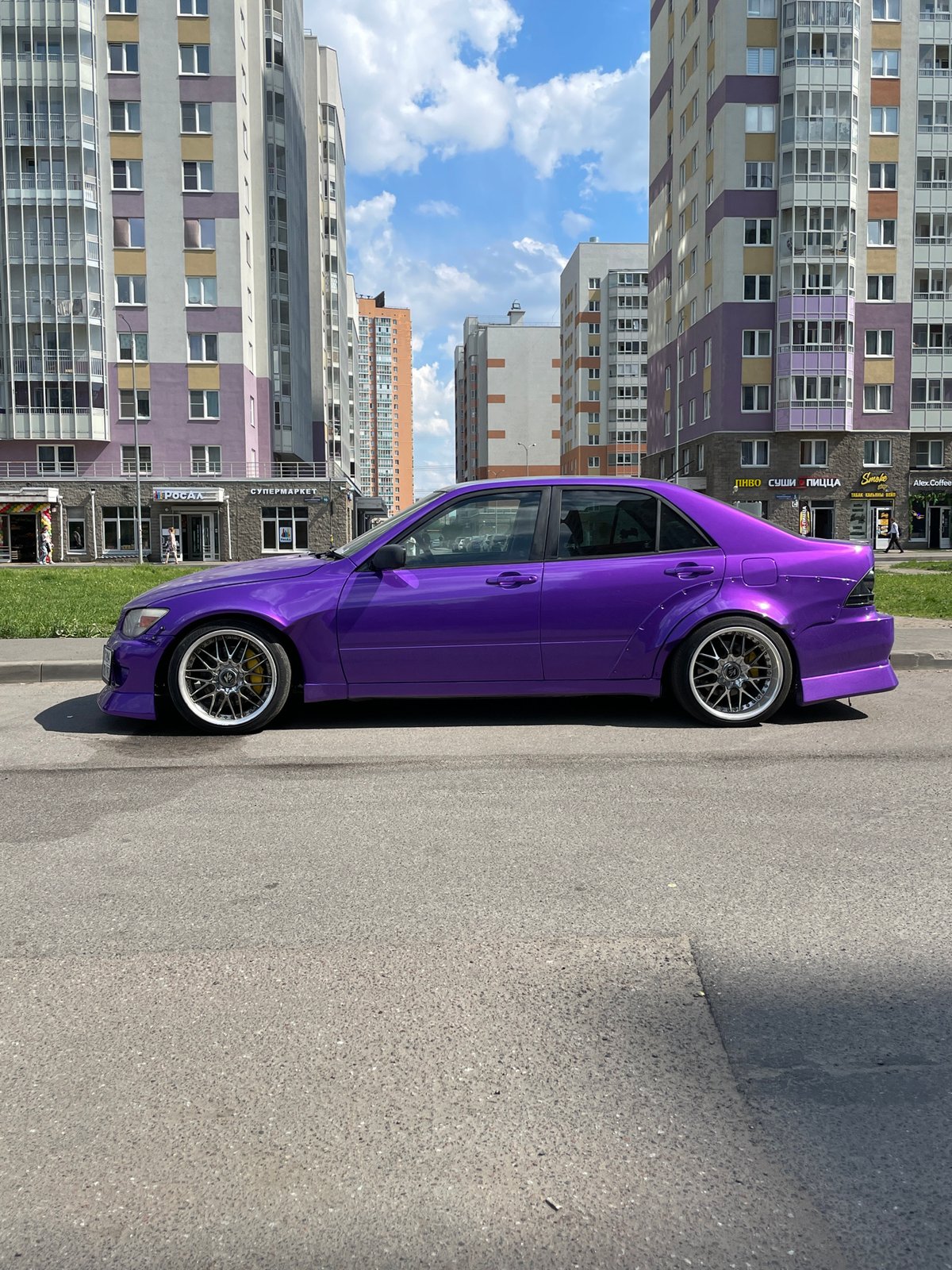 Children play, purple car parked in Russian city