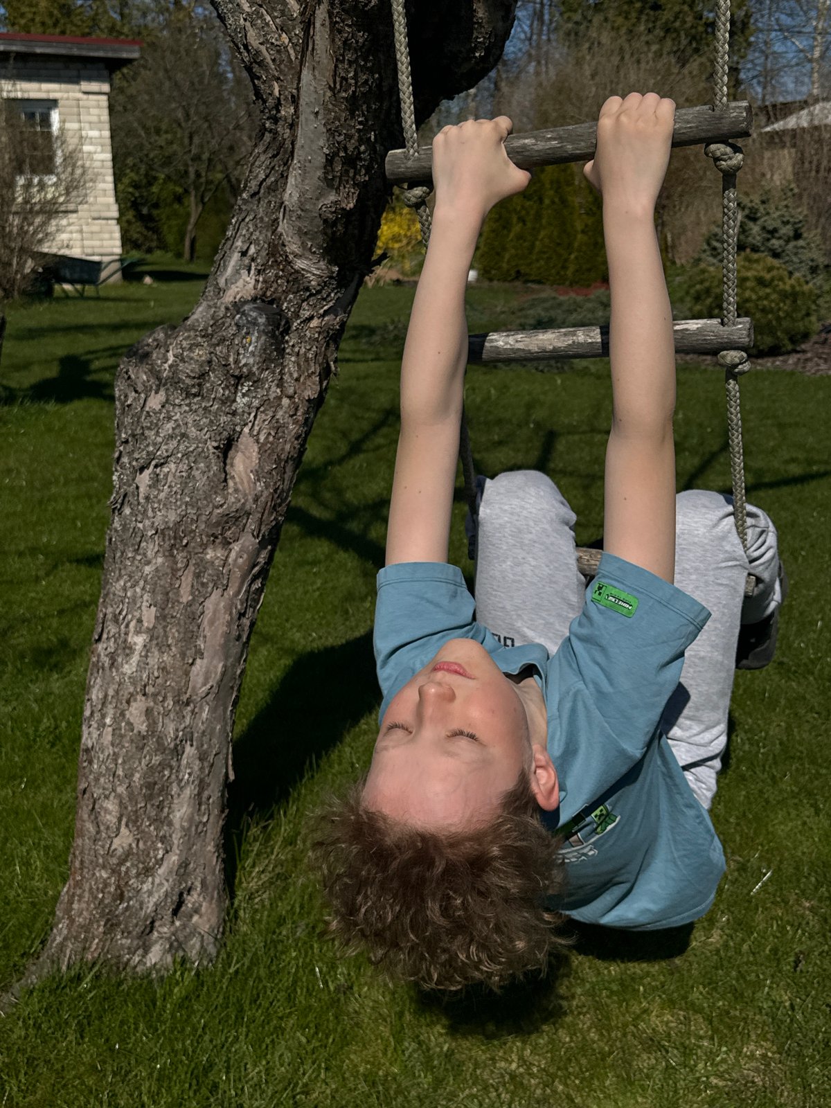 Children play outdoors in sunny Carnikava backyard