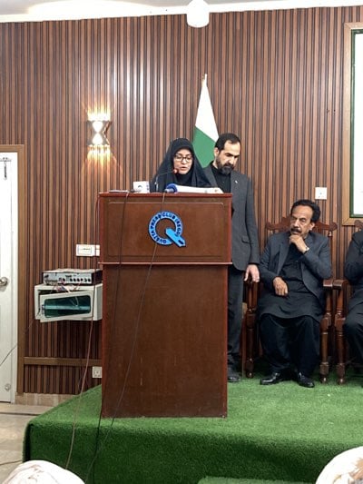 Woman addresses formal gathering at Pakistani venue