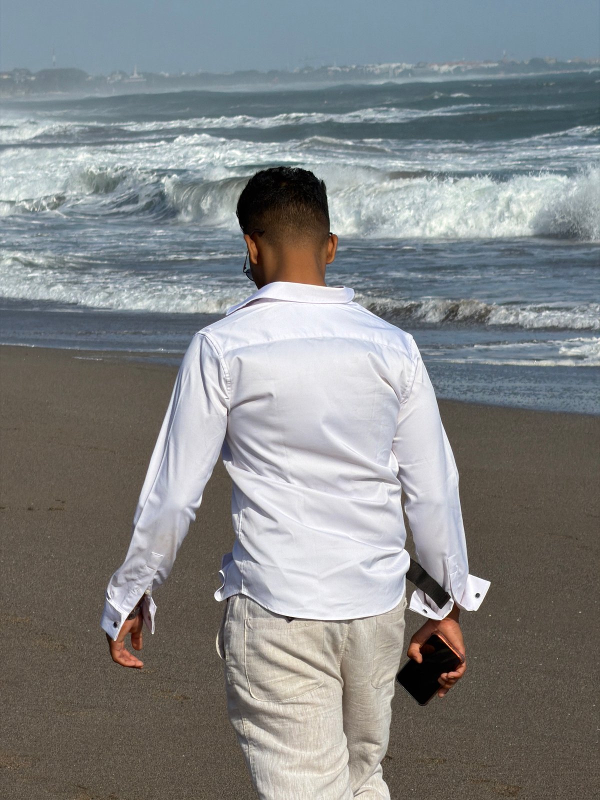 Morning beach activity on North Kuta's dark sand shore