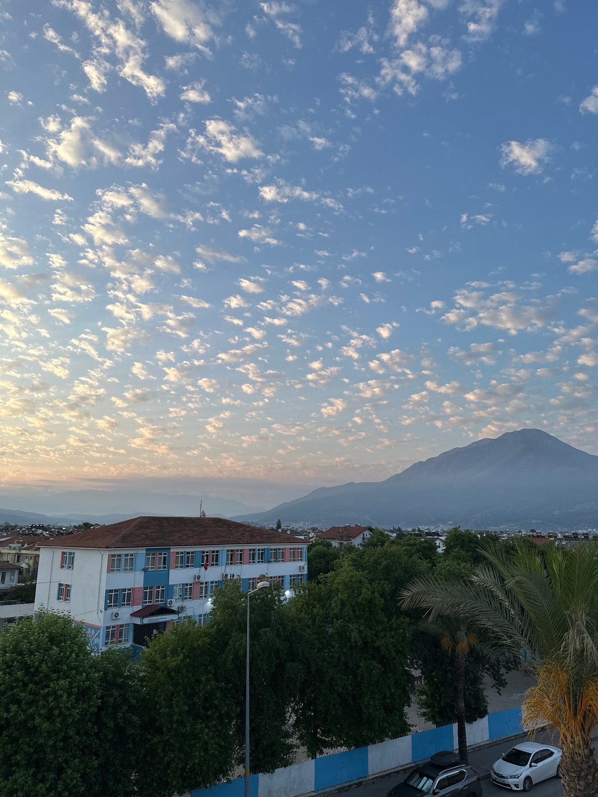 Sunrise over Fethiye, school building and city in morning light