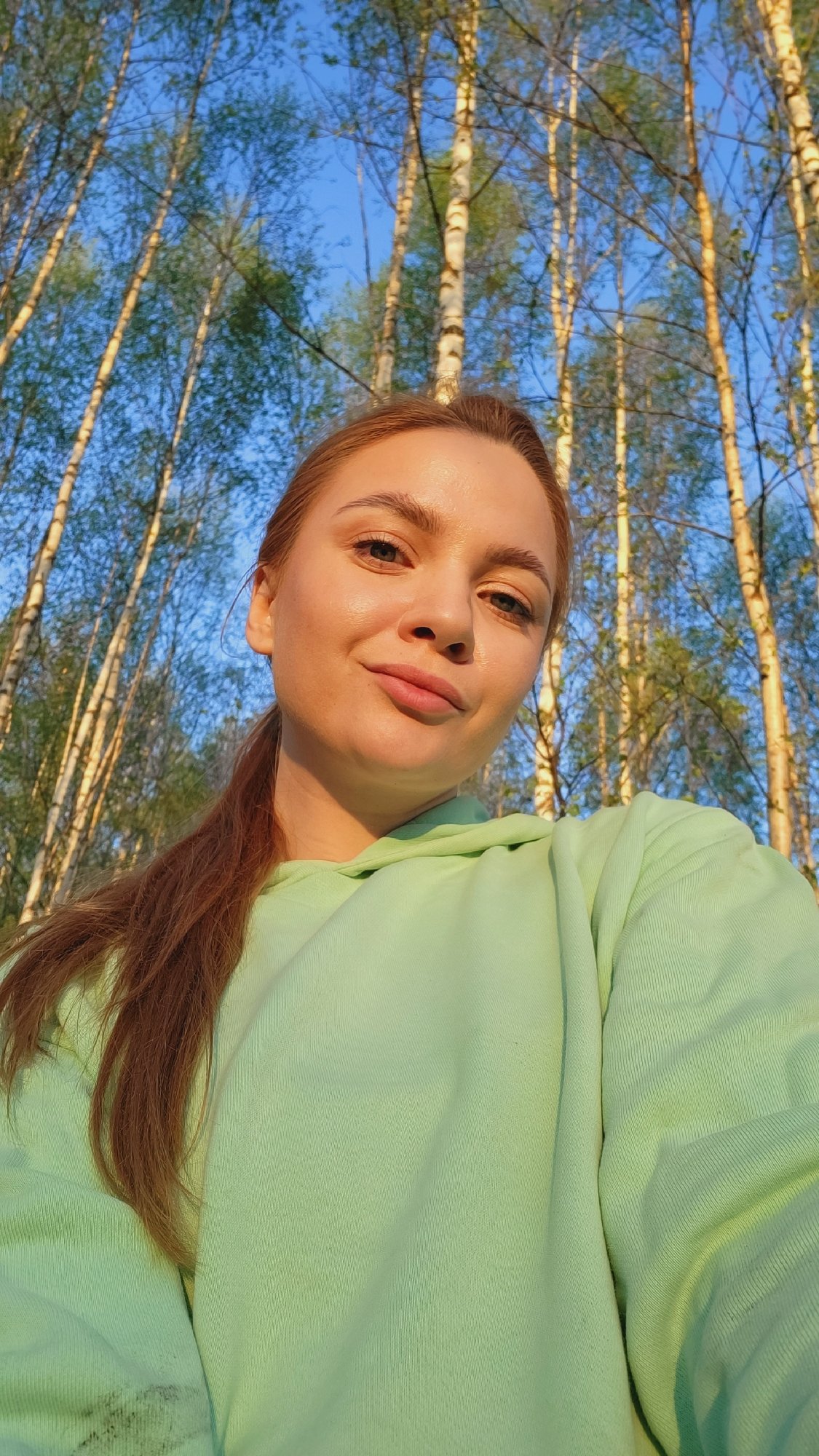 Woman explores birch forest in rural Зипуново, Russia