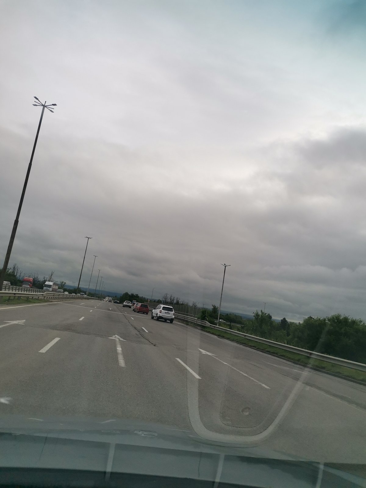 Highway journey documented during overcast morning commute conditions