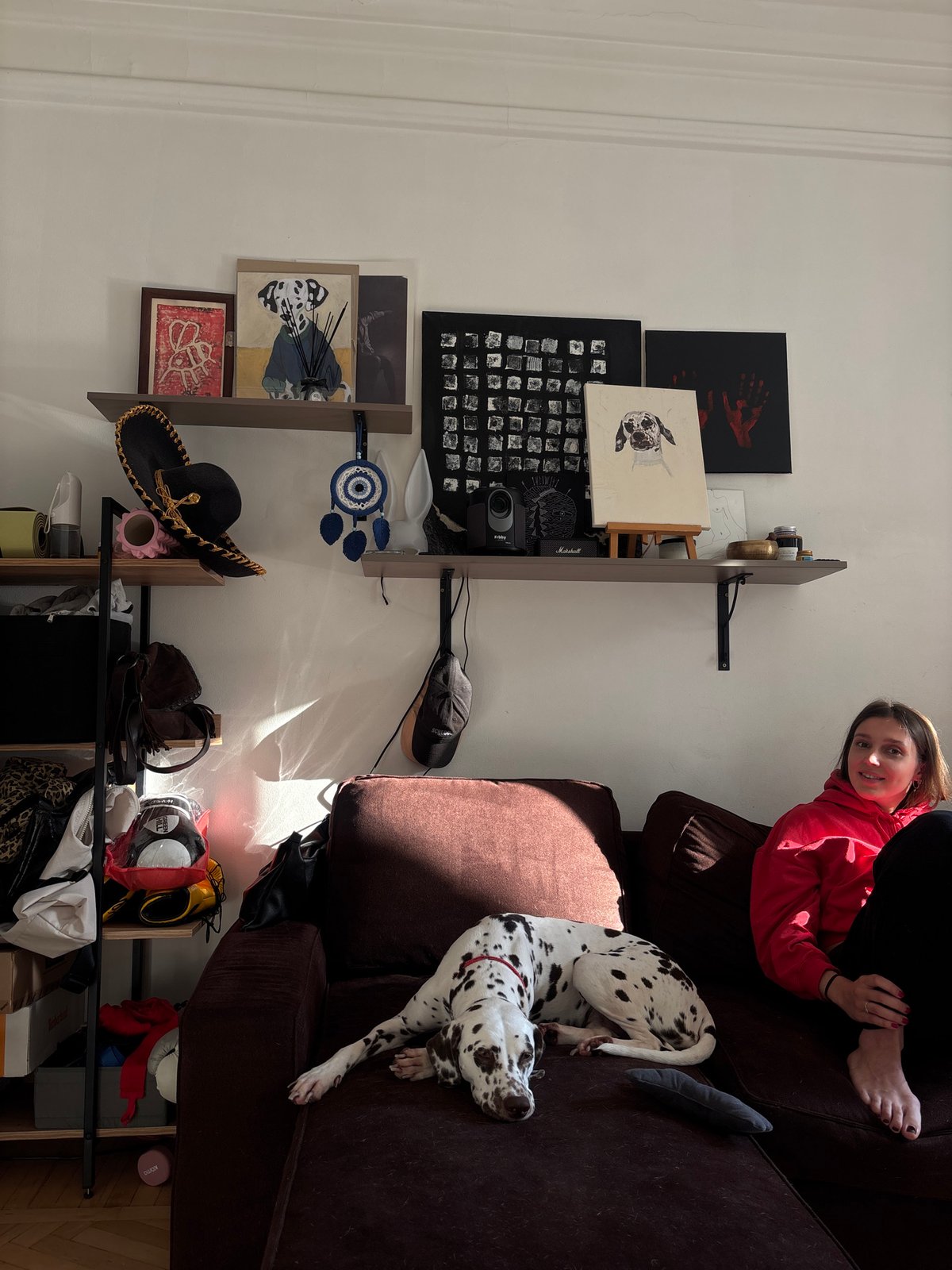 Woman relaxes with Dalmatian dog in sunlit Moscow apartment