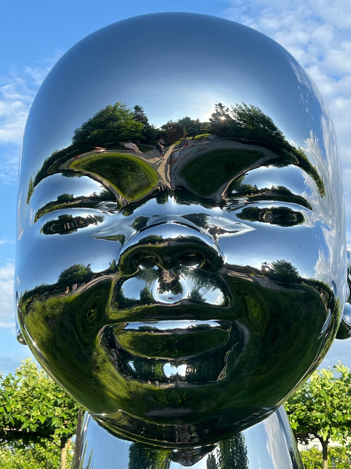 Afternoon in Krasnodar's riverside park among chrome sculptures