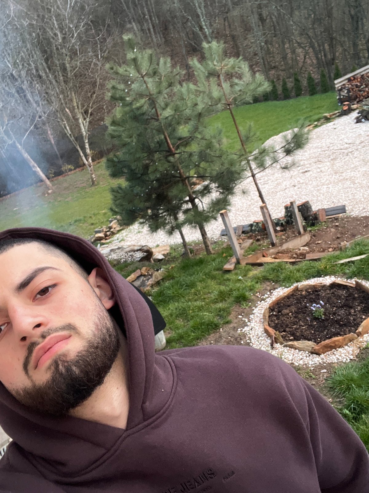 Man takes selfie in Bulgarian backyard with smoke visible