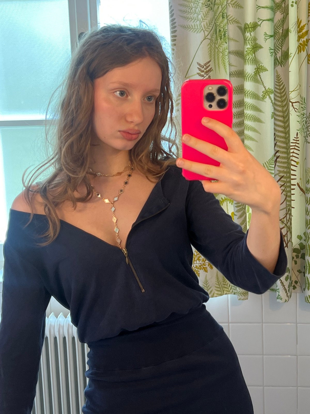 Woman takes bathroom selfie with pink iPhone in Vienna
