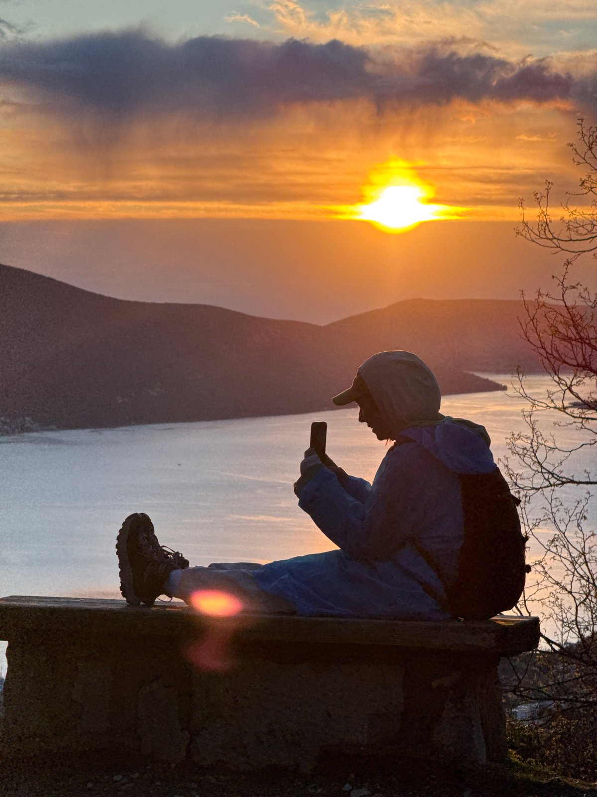 Person watches sunset over Bay of Kotor, Montenegro