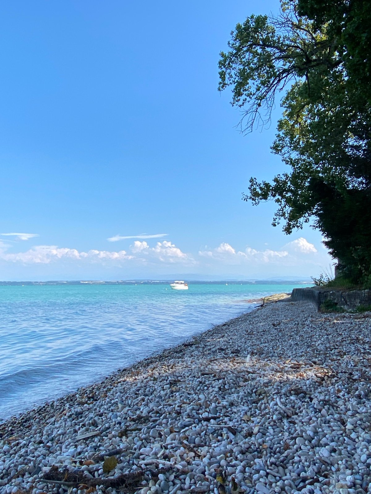 Calm afternoon on Lake Neuchâtel's pebble shore