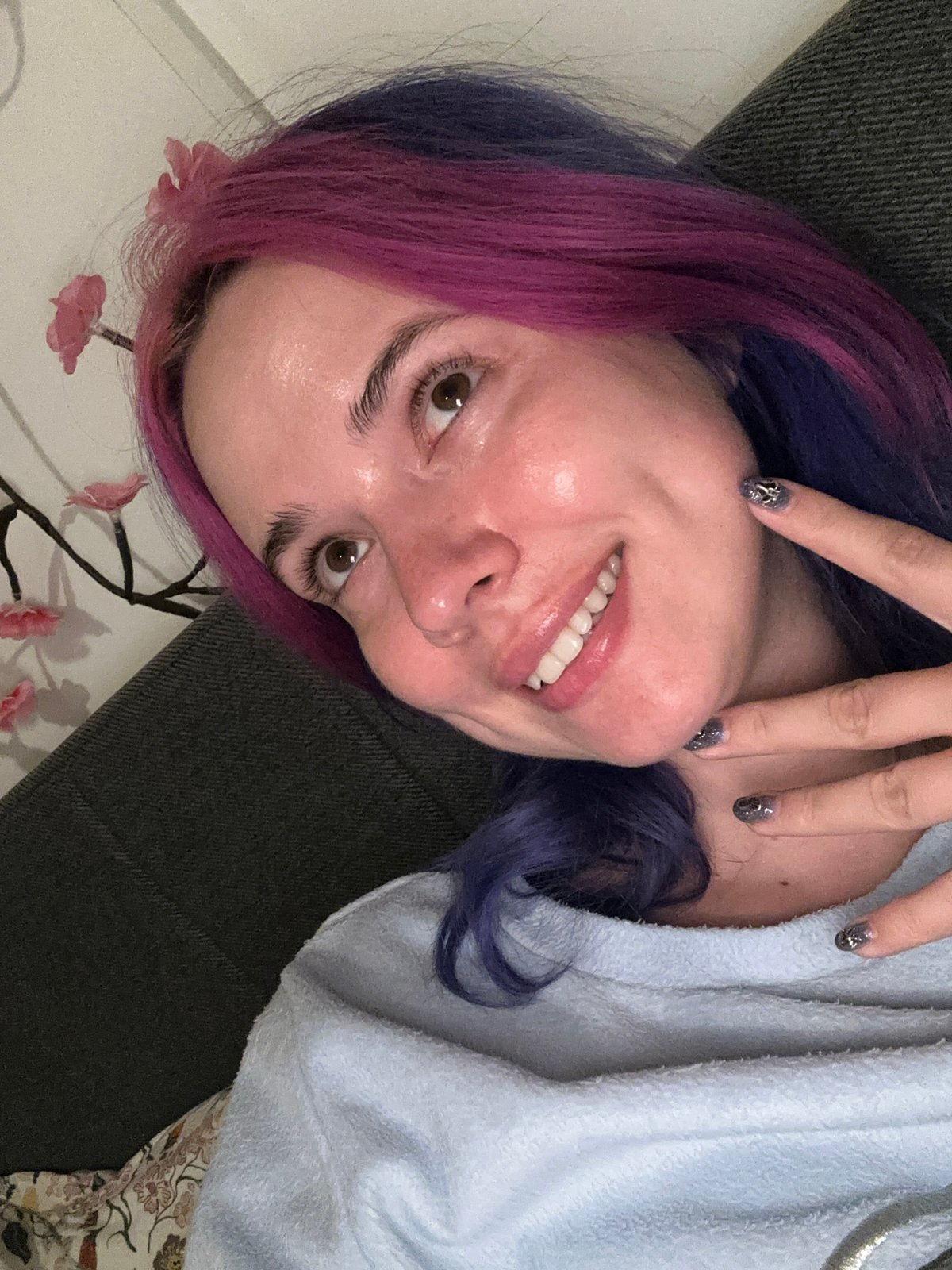 Woman takes colorful-haired selfies on Zagreb couch