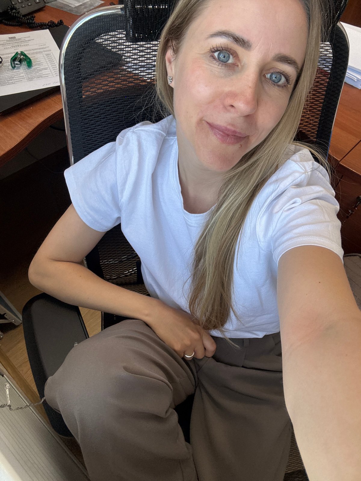 Woman observed at office desk in Chaikovsky, Russia