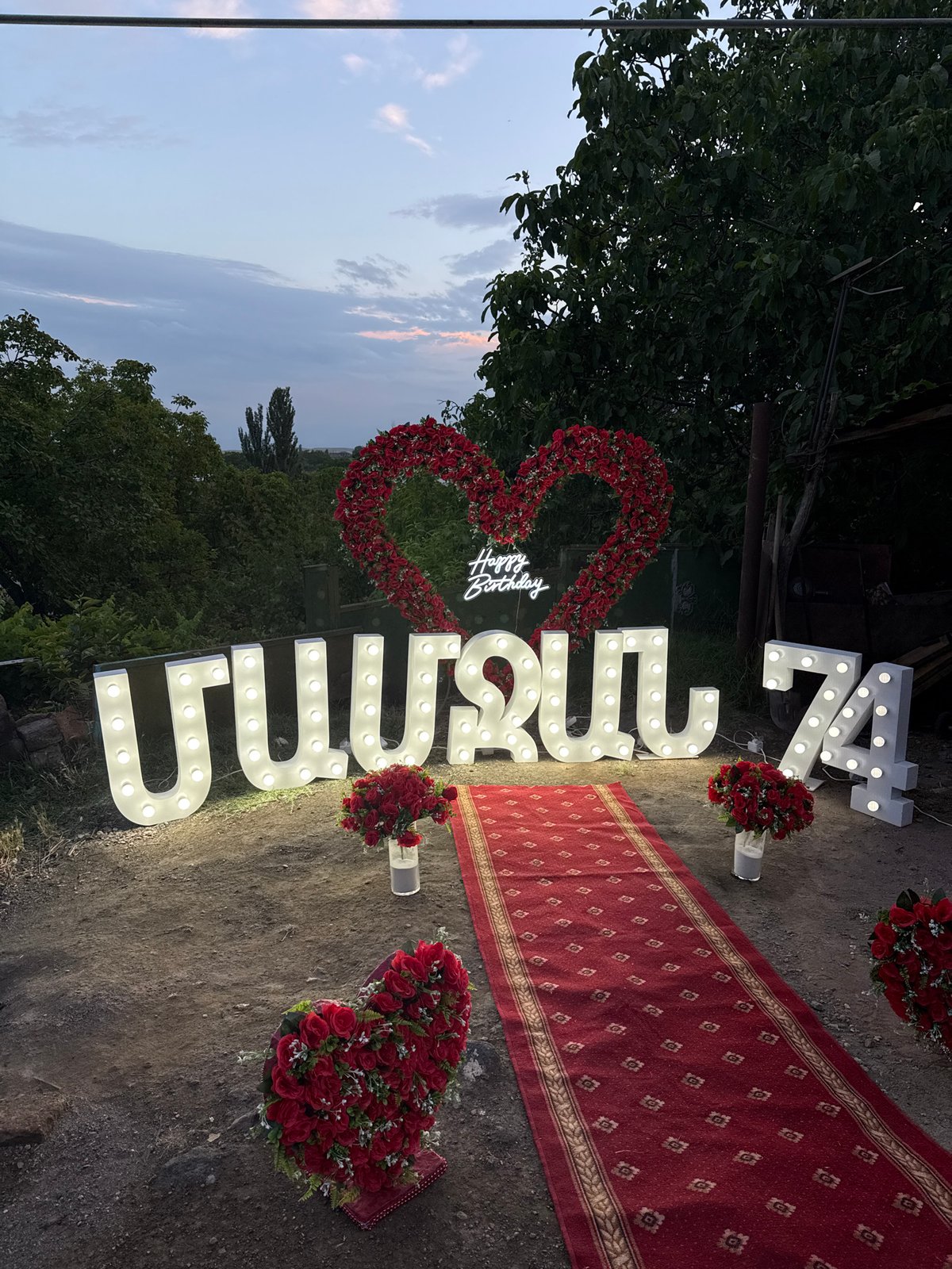 Milestone celebration with roses and marquee lights in Kosh, Armenia