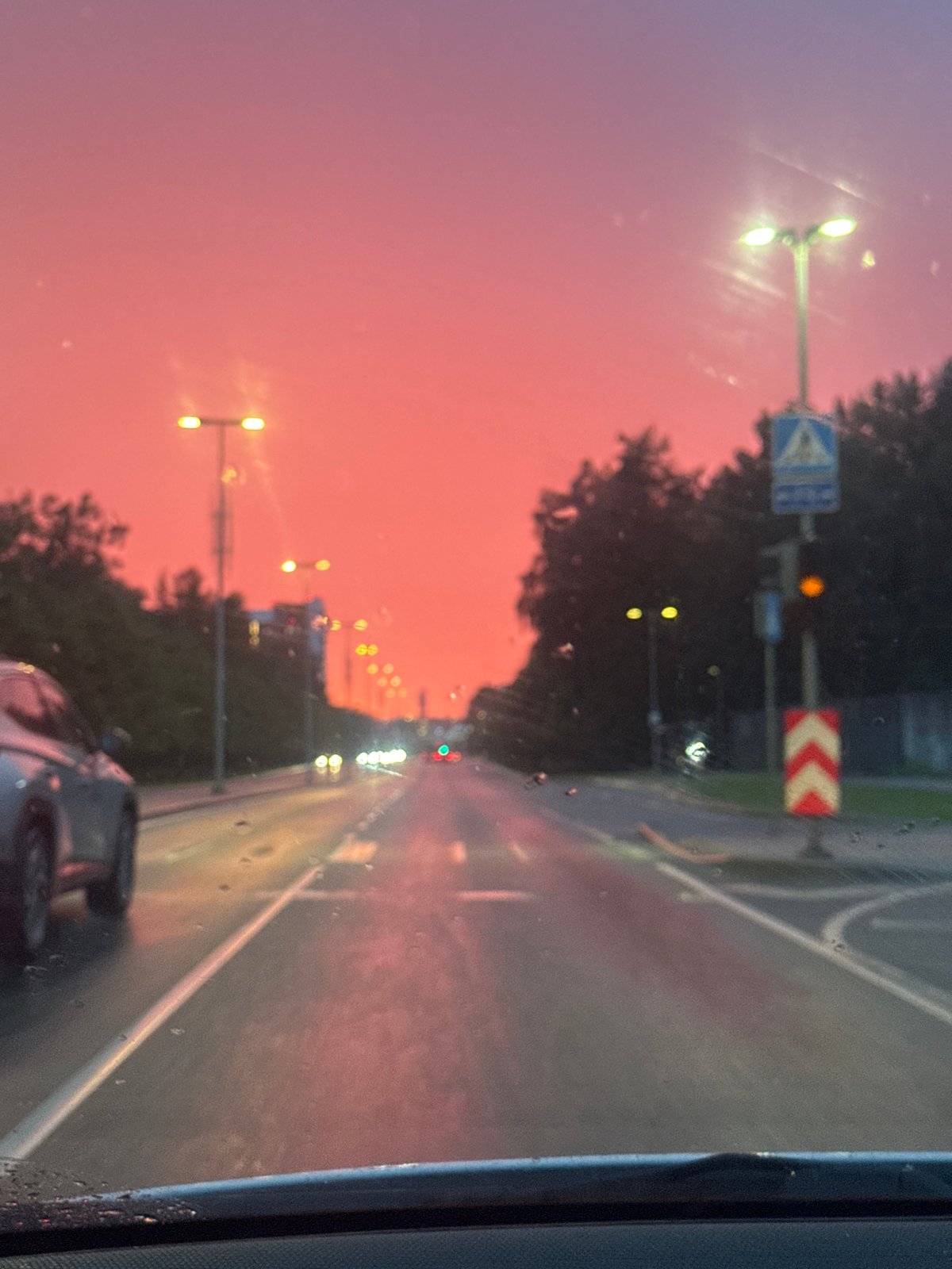 Driving through rainy Tallinn under a vivid summer sunset