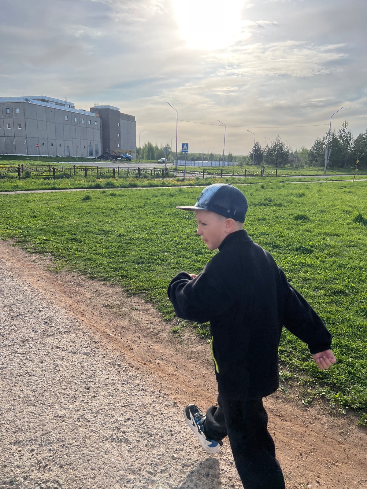 Young person walks dirt path in Марковský early morning