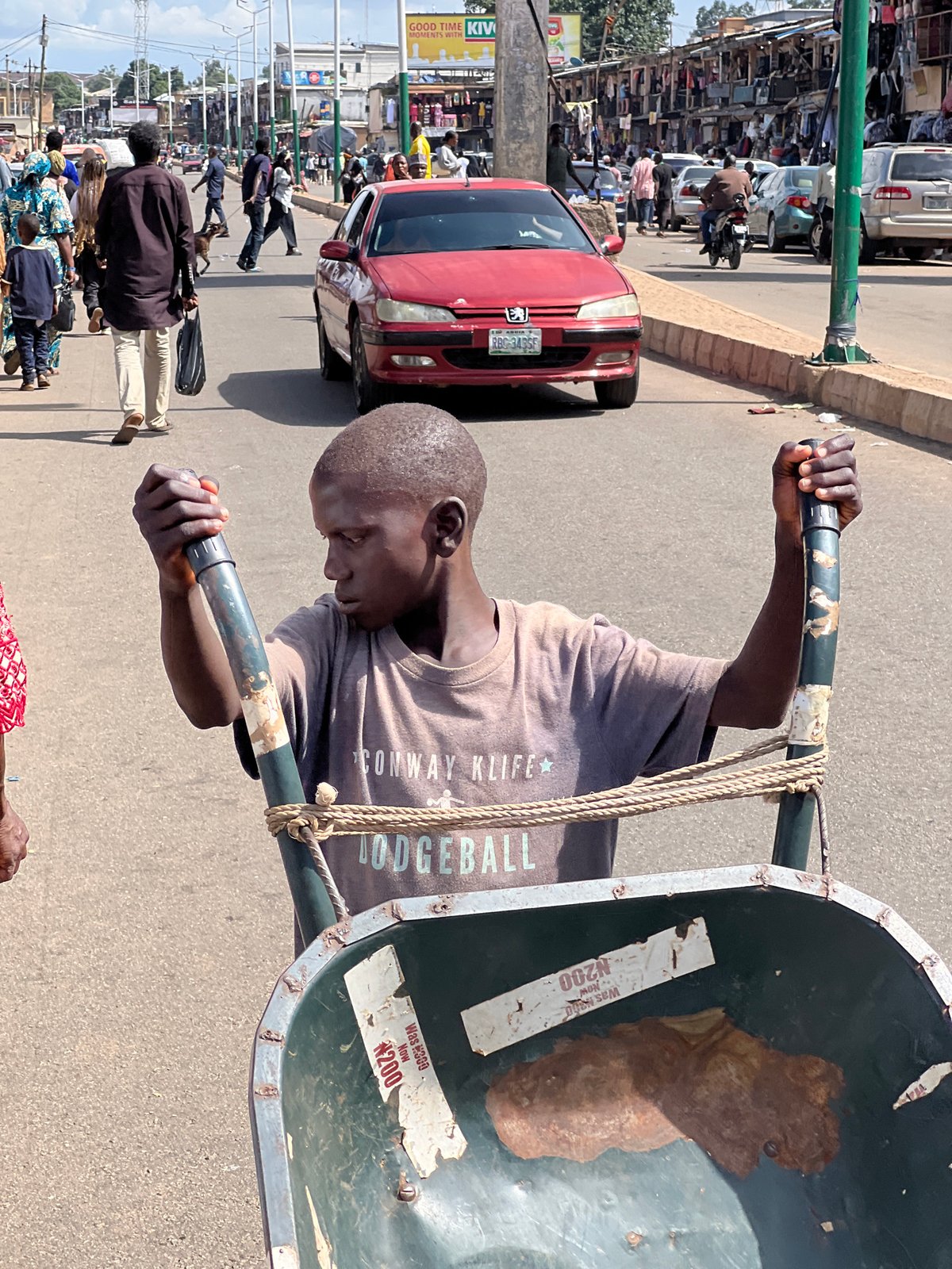 Afternoon street life across Jos market district