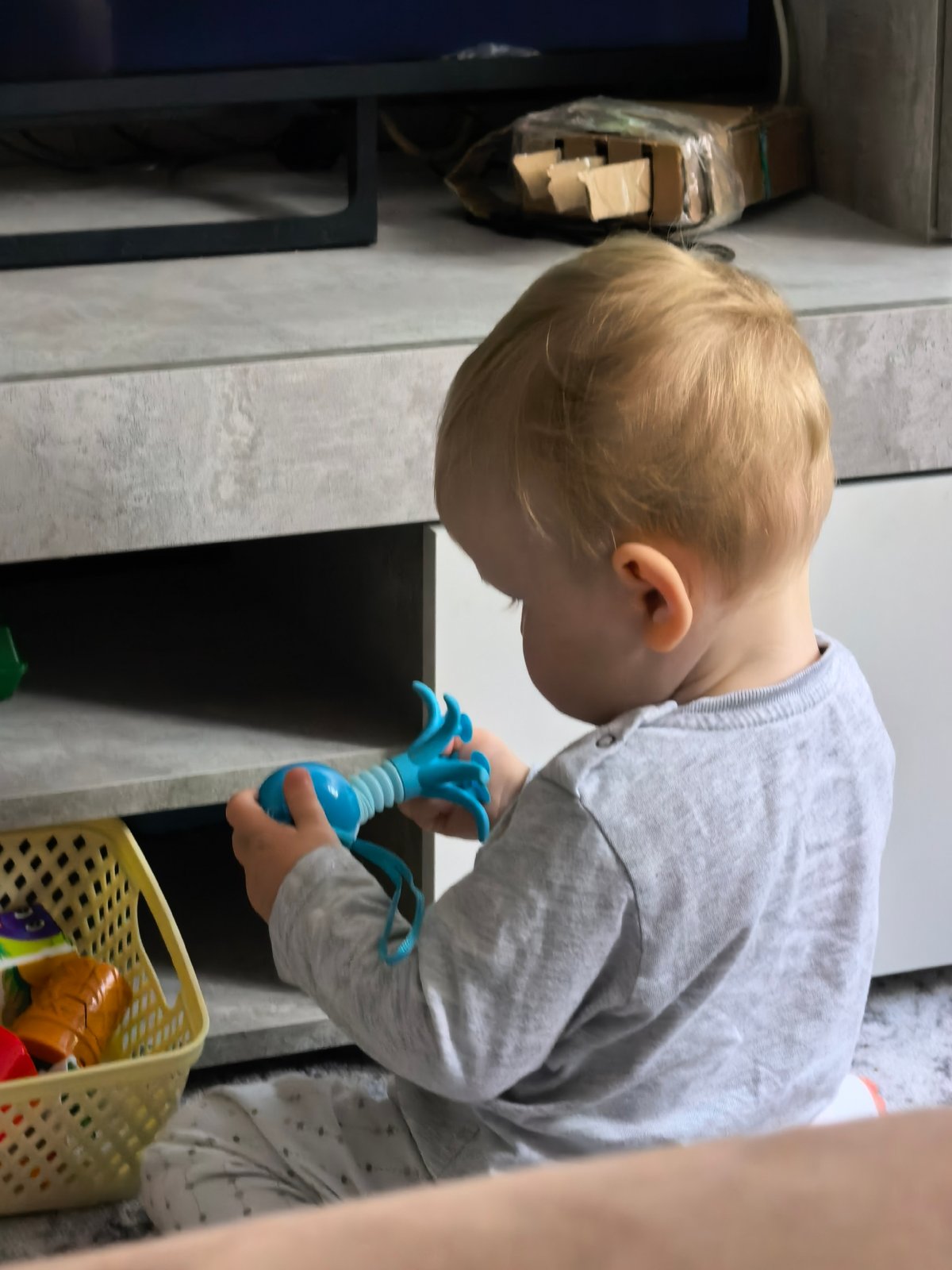Toddler plays with Pop It toy in Sterlitamak