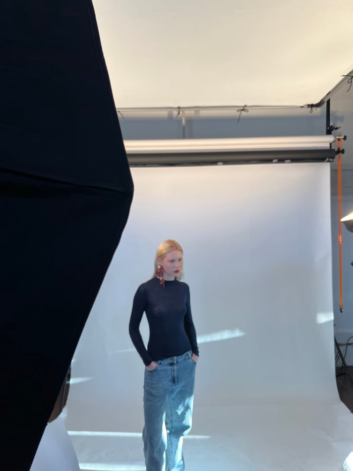 Photography studio session documented in Paris with model and crew