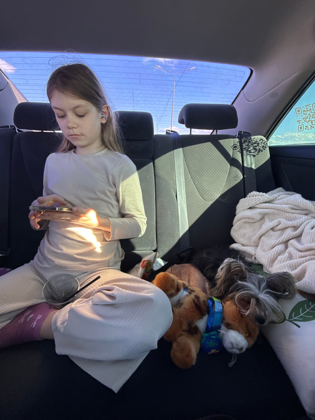 Woman rests in vehicle backseat in Losevo, Russia