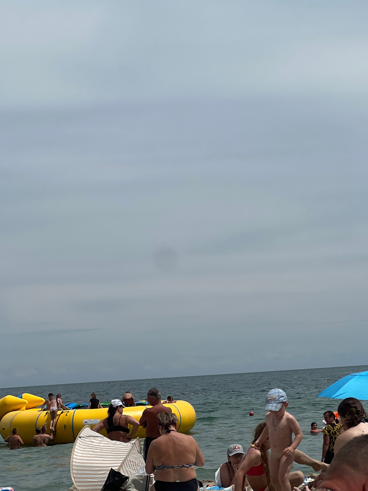 Crowded Odesa beach on a gray summer morning