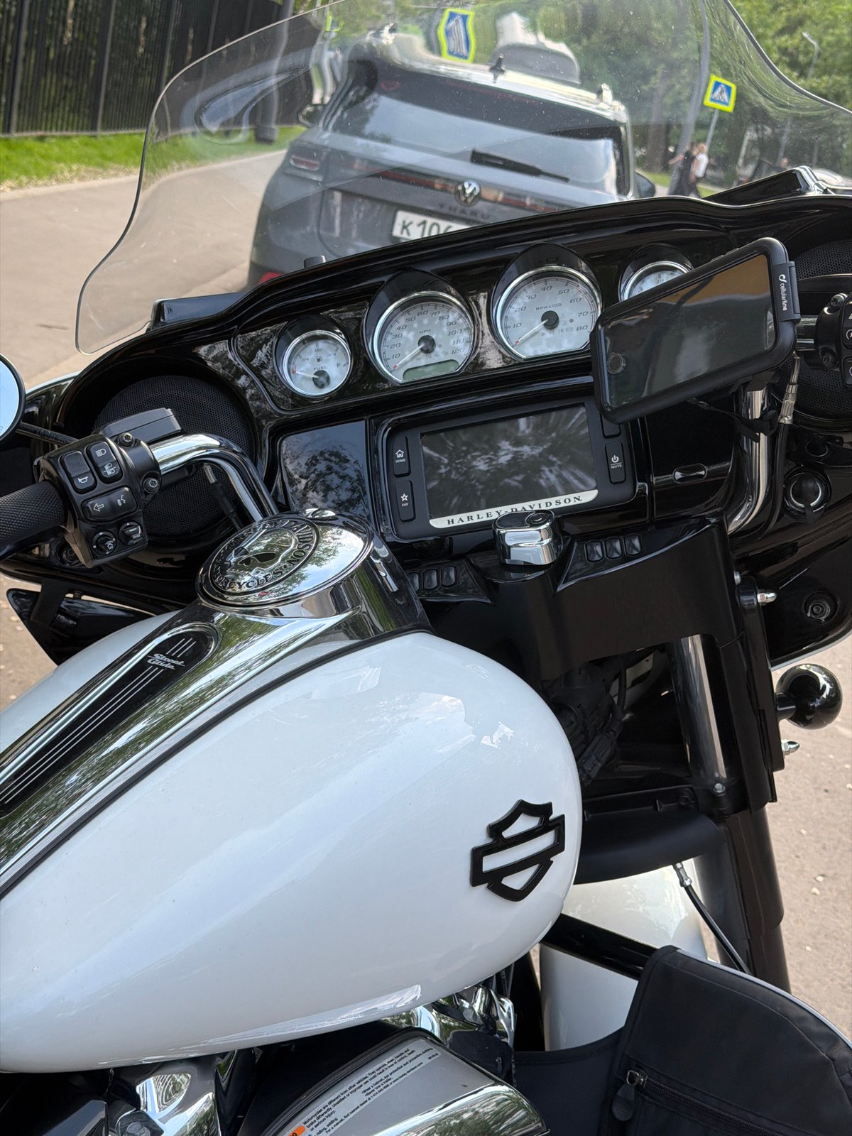 Harley-Davidson motorcycle parked beside Opel car in Moscow