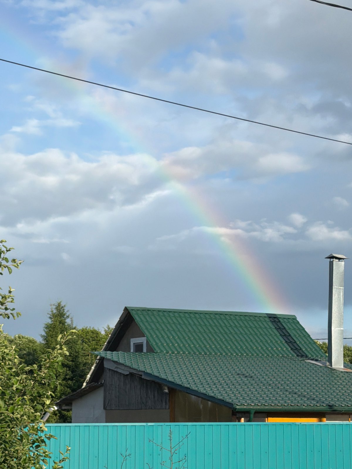 Rainbow over Moscow suburbs, lakes, and a lazy summer afternoon