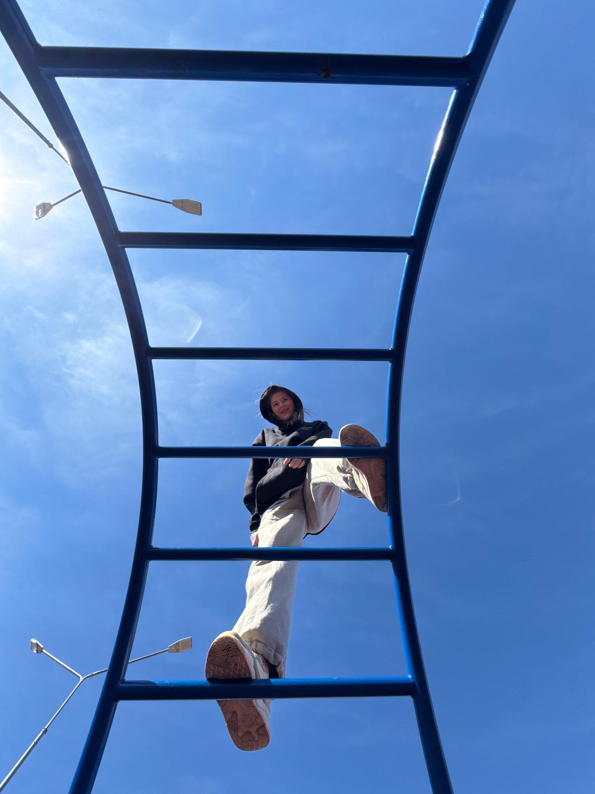 Child plays on colorful playground equipment in Горный, Russia