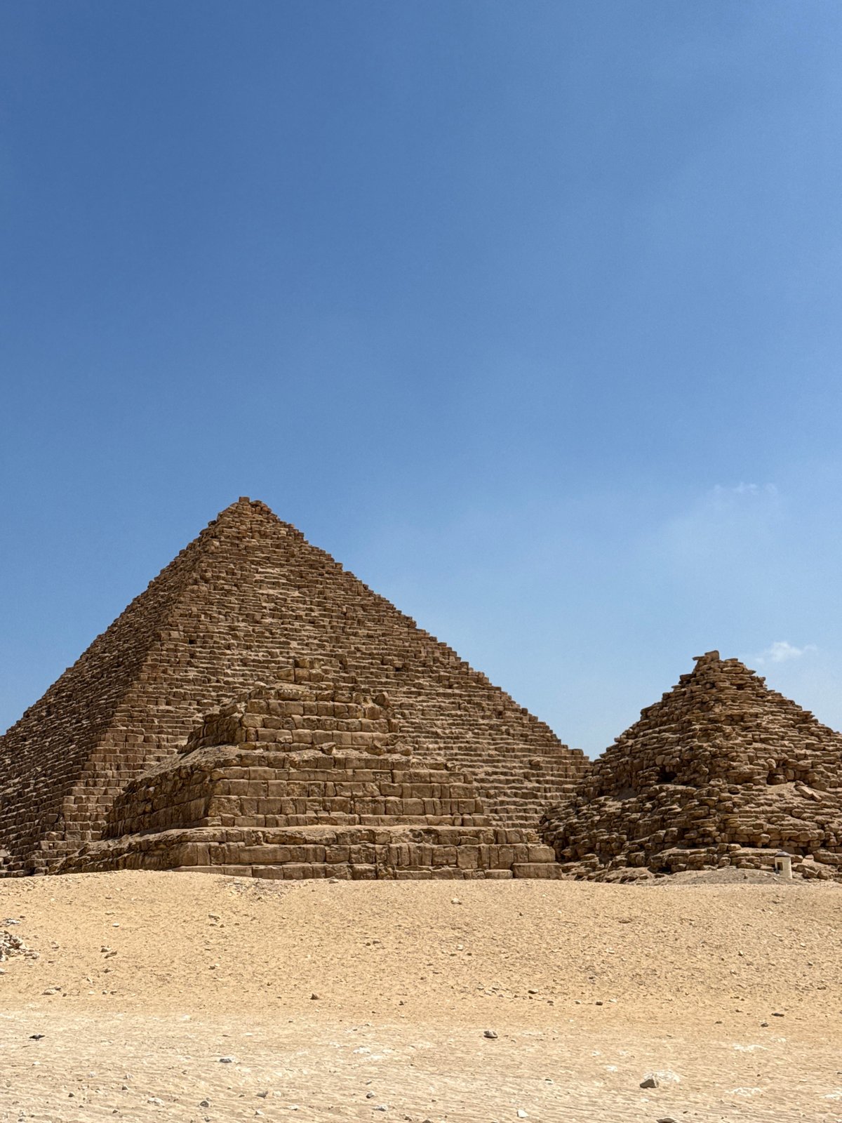 Two Giza pyramids under a clear blue Egyptian sky