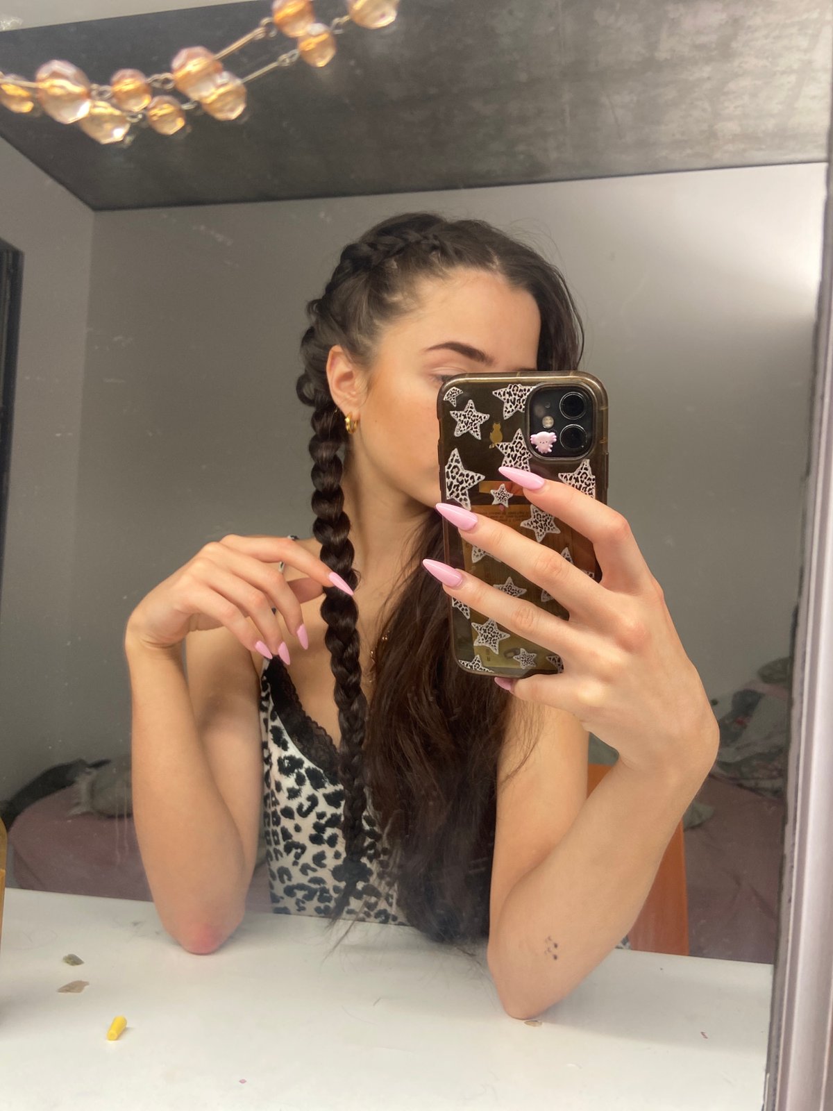 Woman takes mirror selfie in leopard print top, London