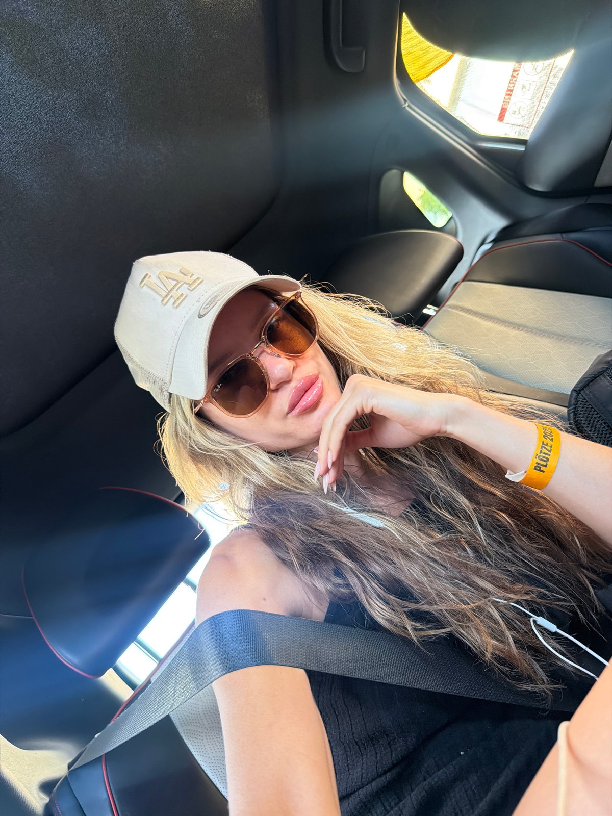 Back seat selfie in a Berlin car with red-stitched leather