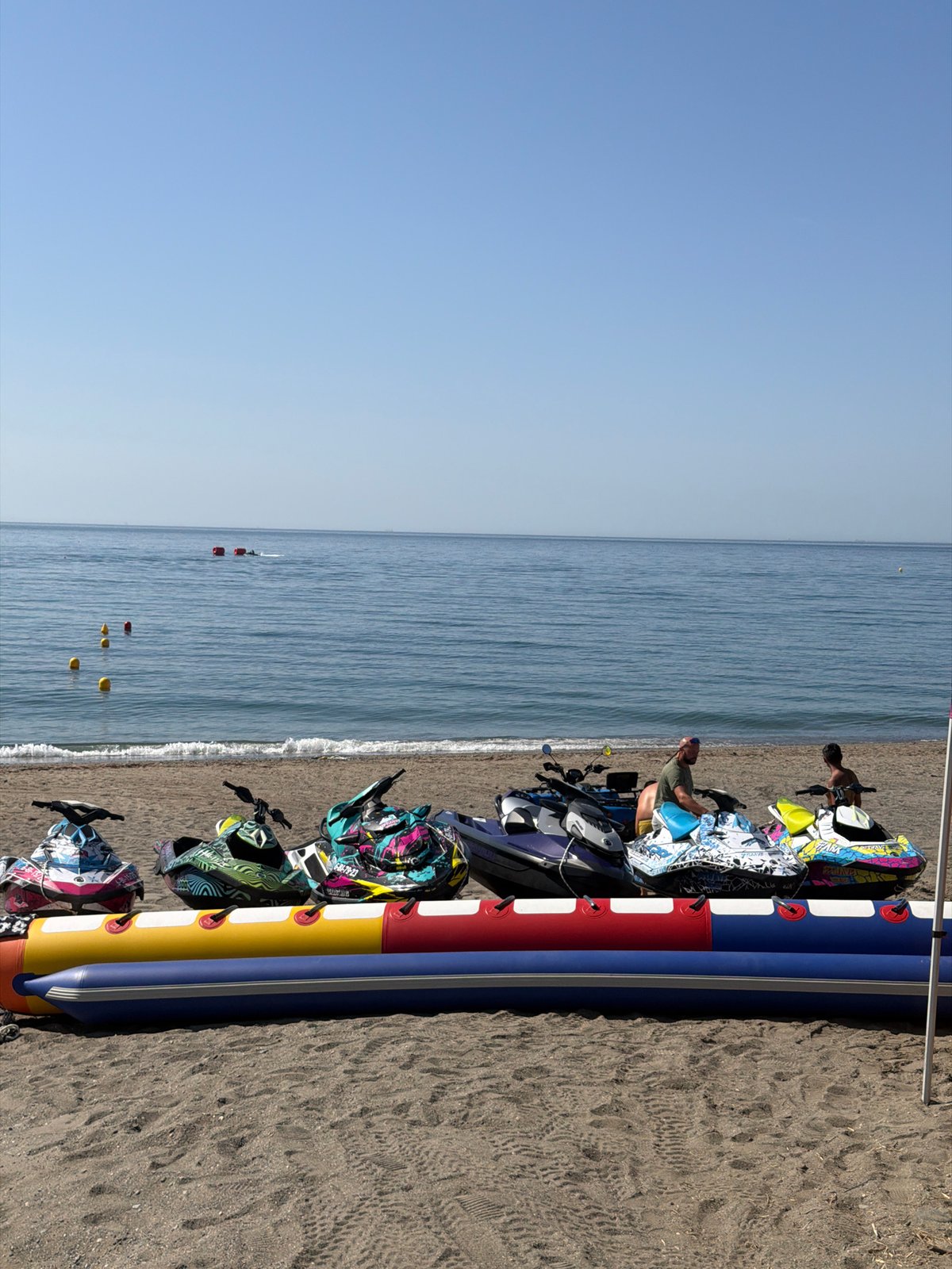 Summer morning on the Estepona coast: water sports, history, and smoke