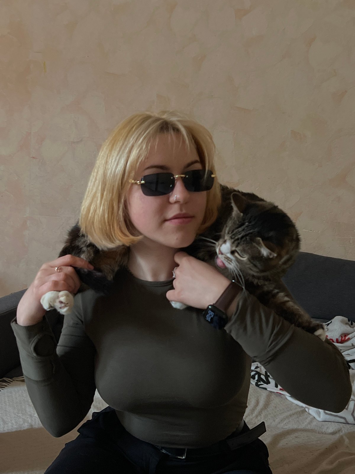 Person photographed with pets in indoor Odesa setting