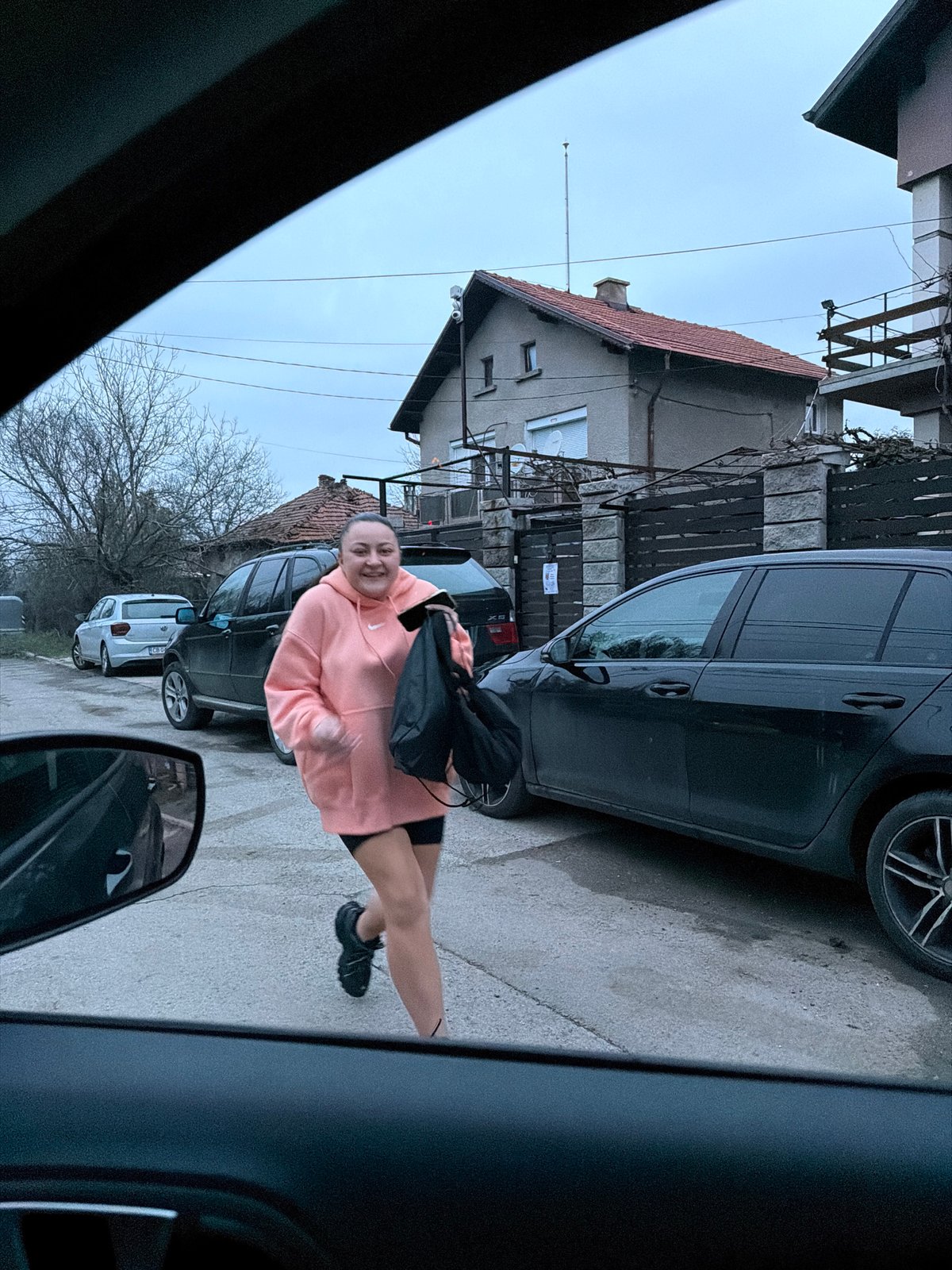 Woman poses for photo on residential street in Dragichevo