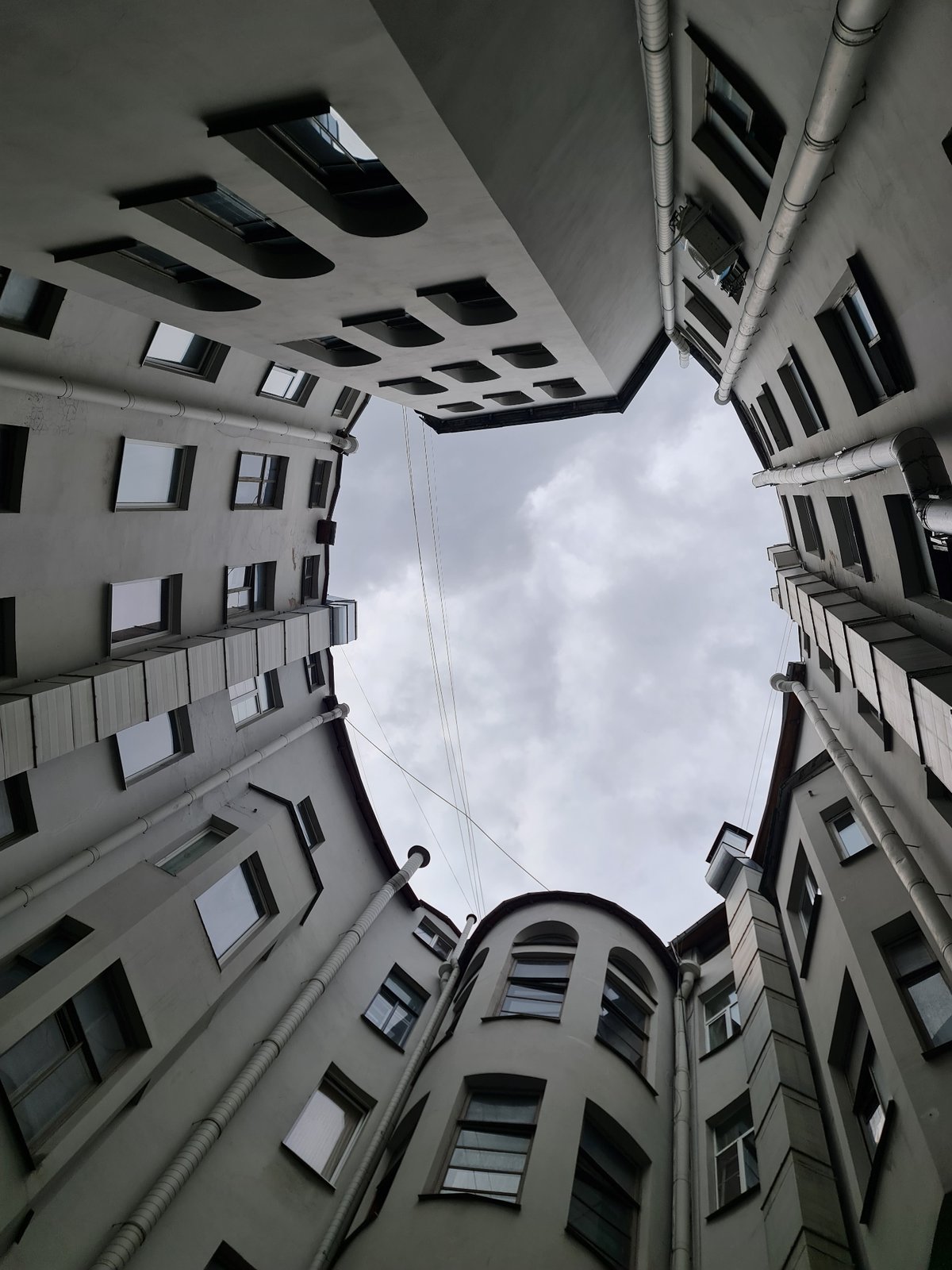 Looking up from a gray Saint Petersburg courtyard