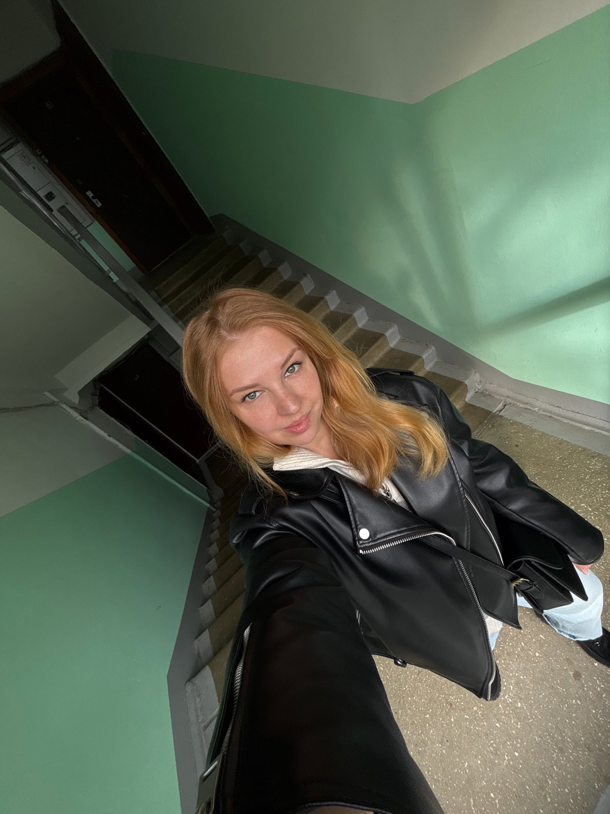 Person photographed twice in different outfits in Podosenikha building