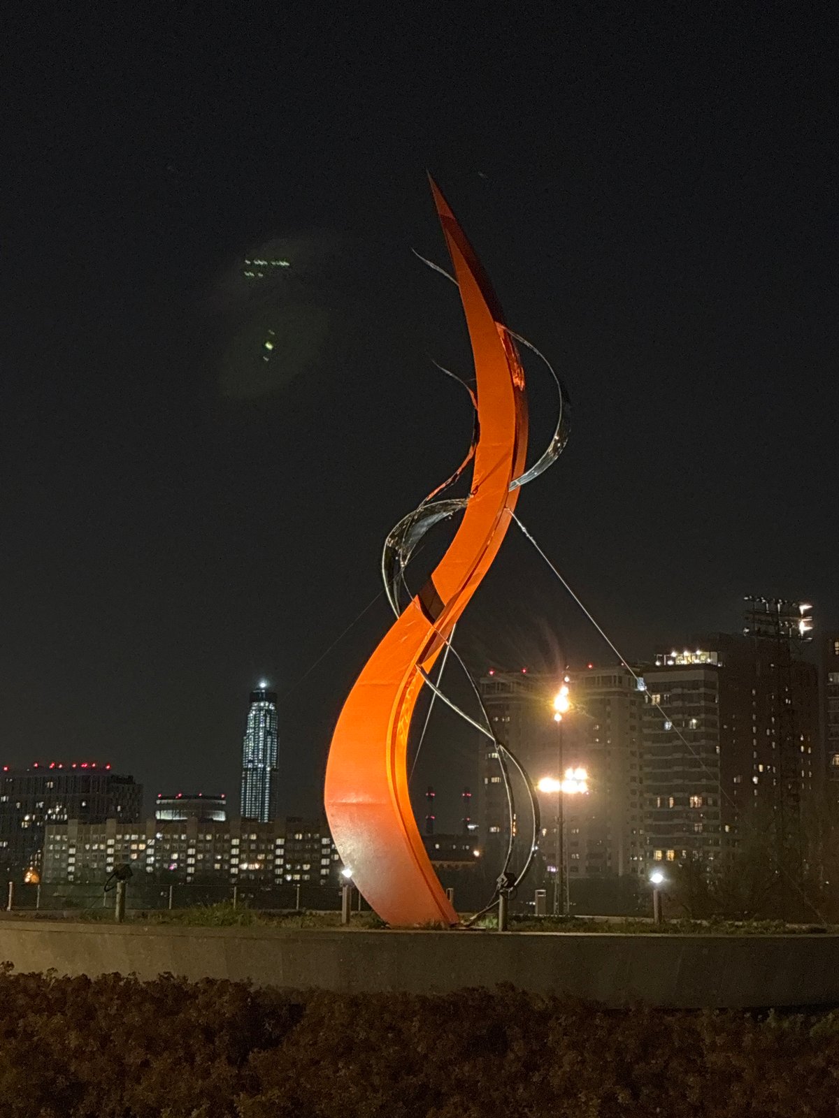 Urban night scenes: sculpture, flags, bicycle documented over 8 minutes