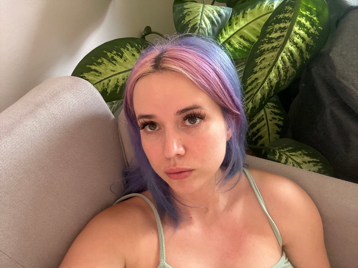 Woman with colorful hair photographed on sofa in Gijón
