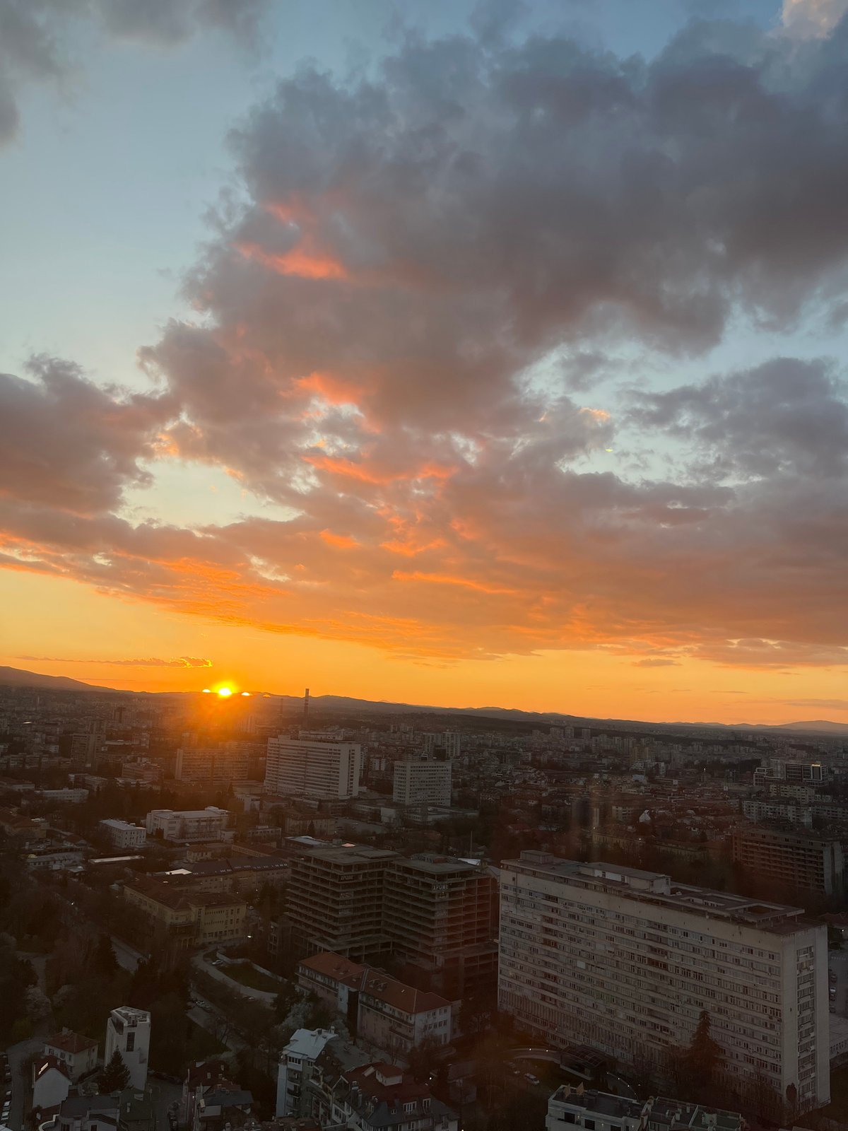 Sunset documented over Sofia skyline from elevated viewpoint