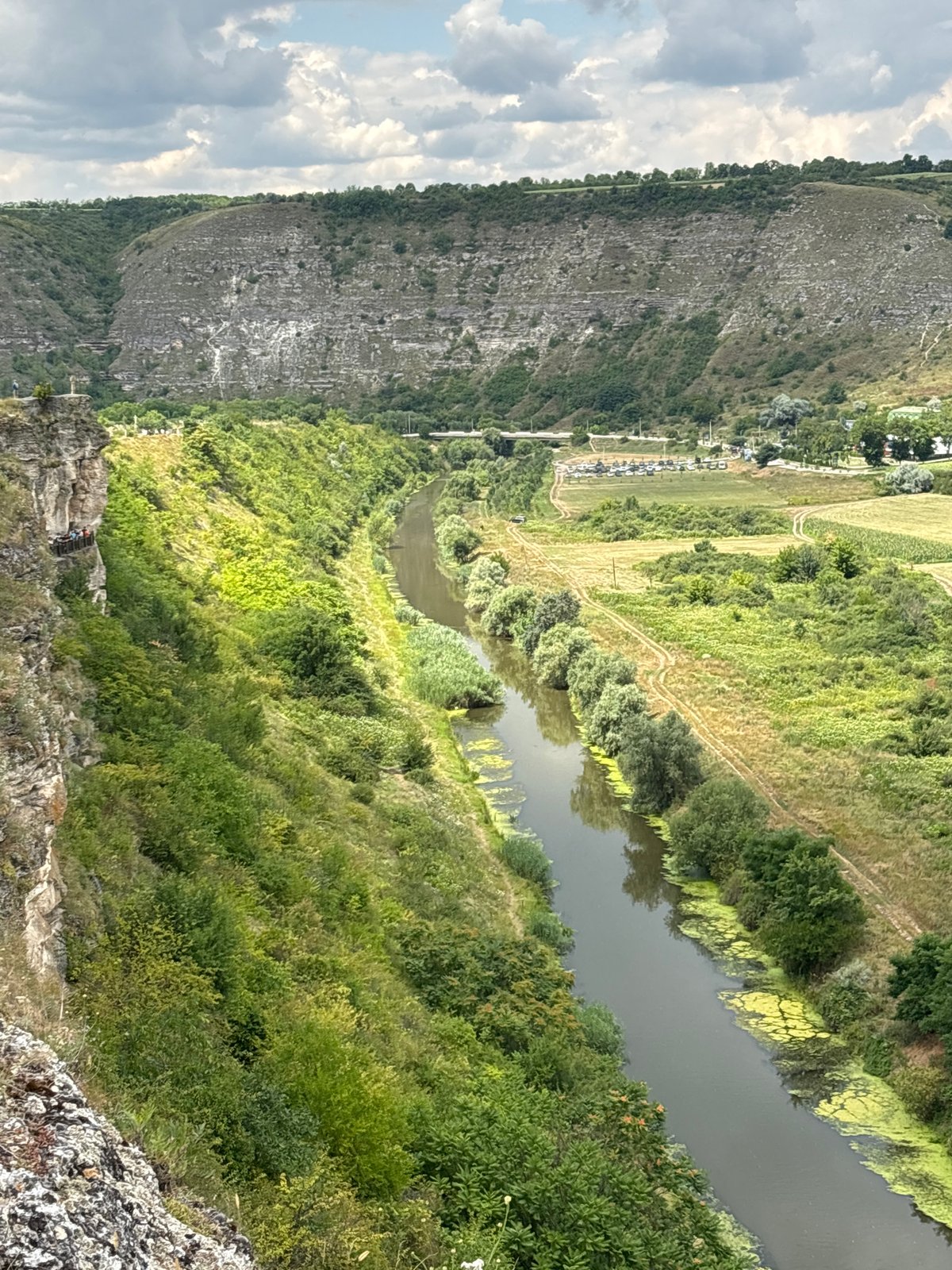 Wooden cliff platform overlooks a winding river valley in Moldova