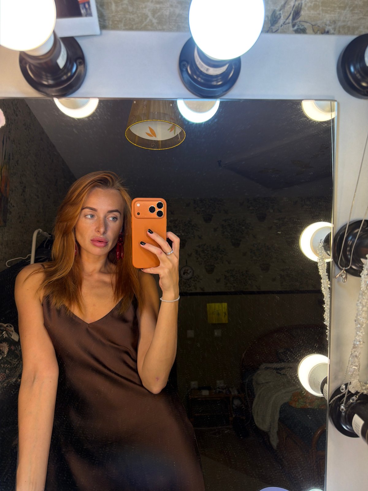 Woman takes vanity mirror selfie in Krasnoyarsk room