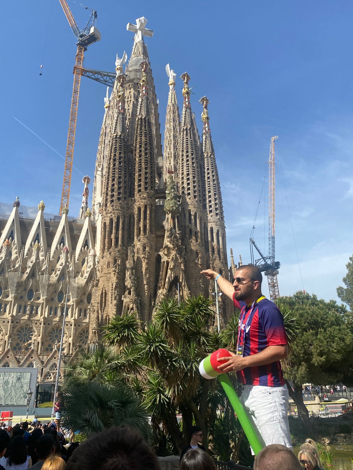 Tourist observes Sagrada Familia on sunny Barcelona morning