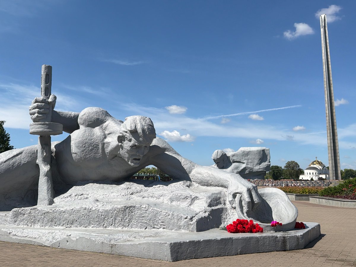 Touring a war memorial: sculptures, paintings, and a flower-laid plaque
