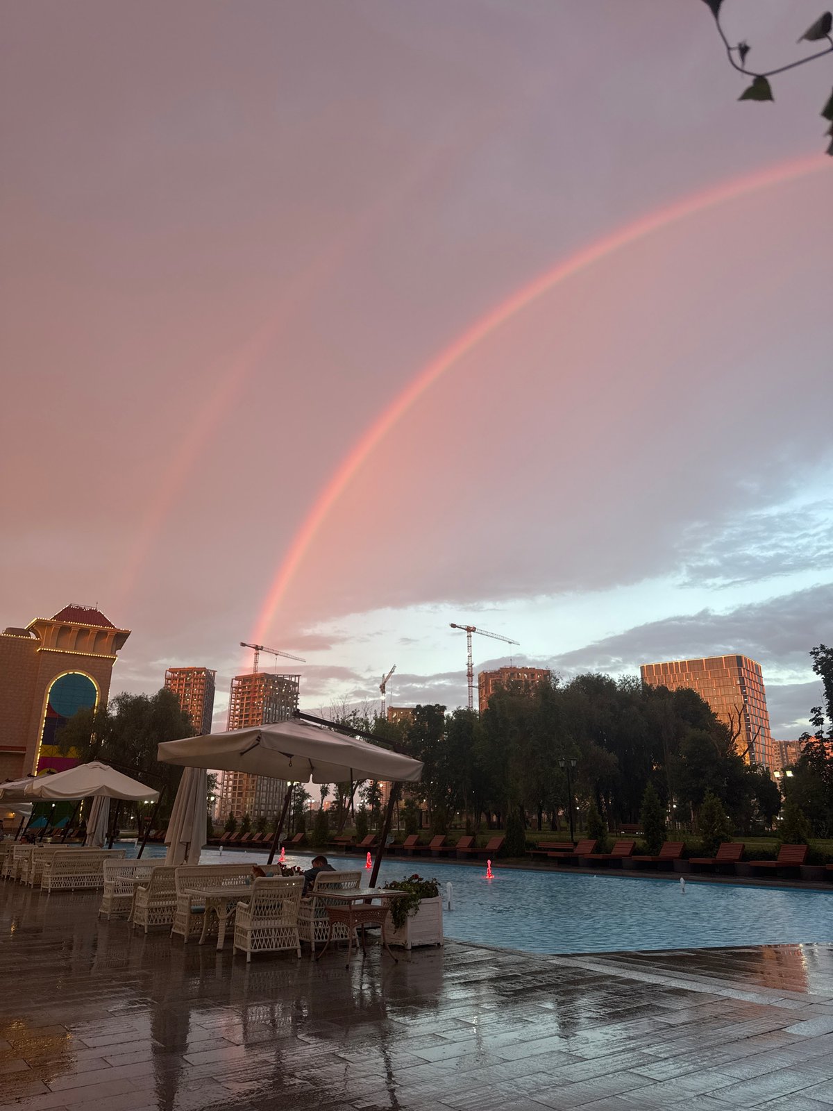 Rainbows over a Moscow pool deck after an evening storm