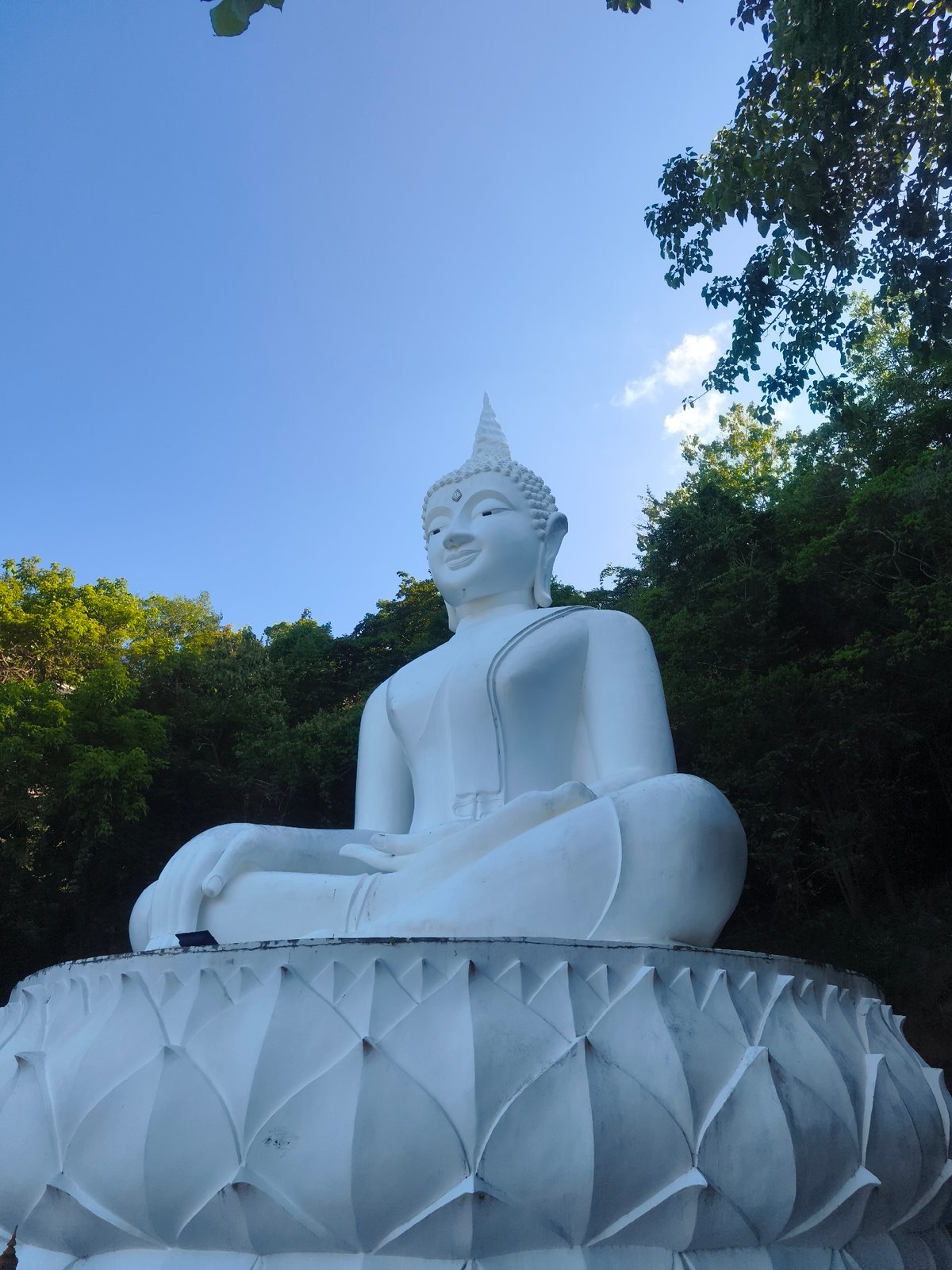 White hillside Buddha statue in Ko Samui, seen from multiple angles