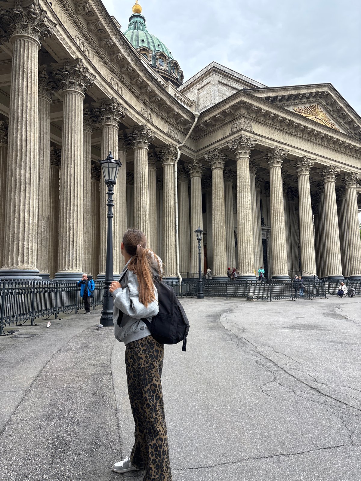 Tourist documents Saint Petersburg's historic cathedral architecture during morning walk
