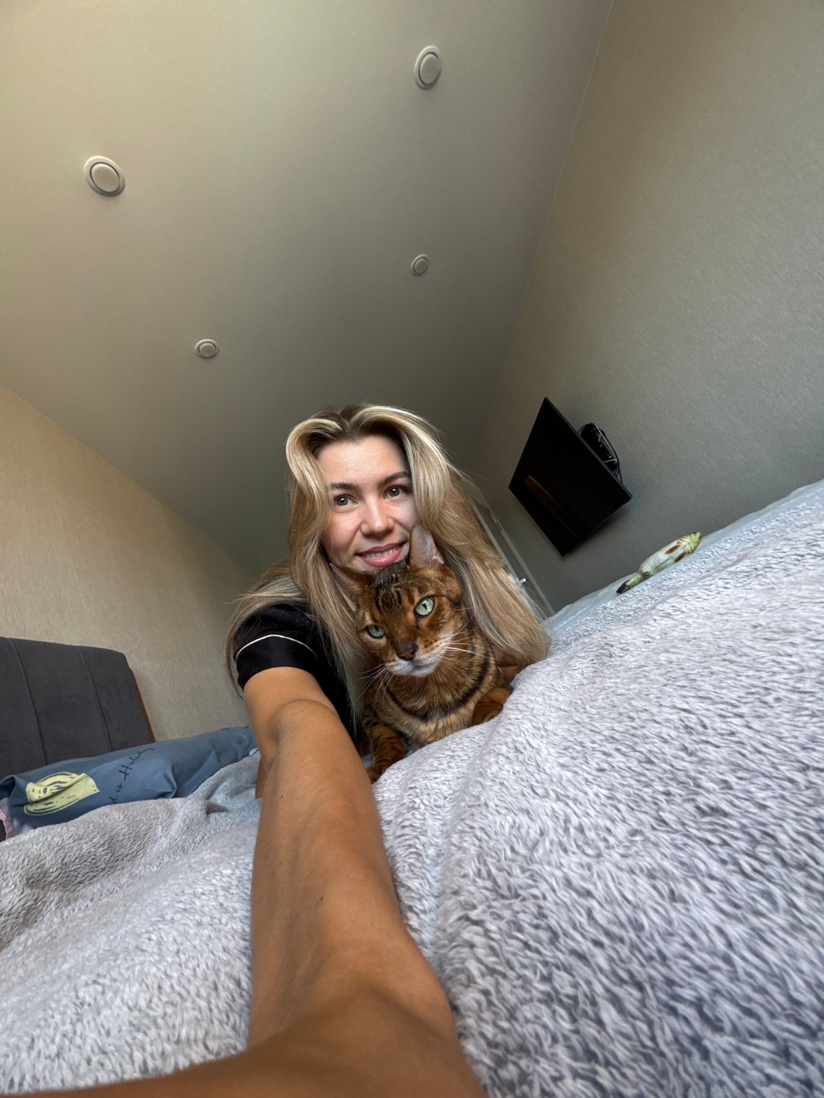 Woman takes bedroom selfies with Bengal cat