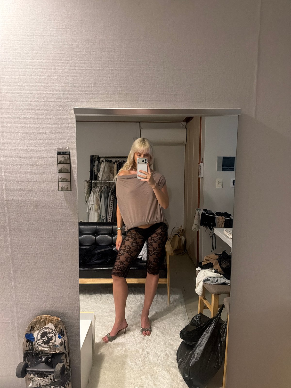 Woman takes mirror selfie in Seoul room