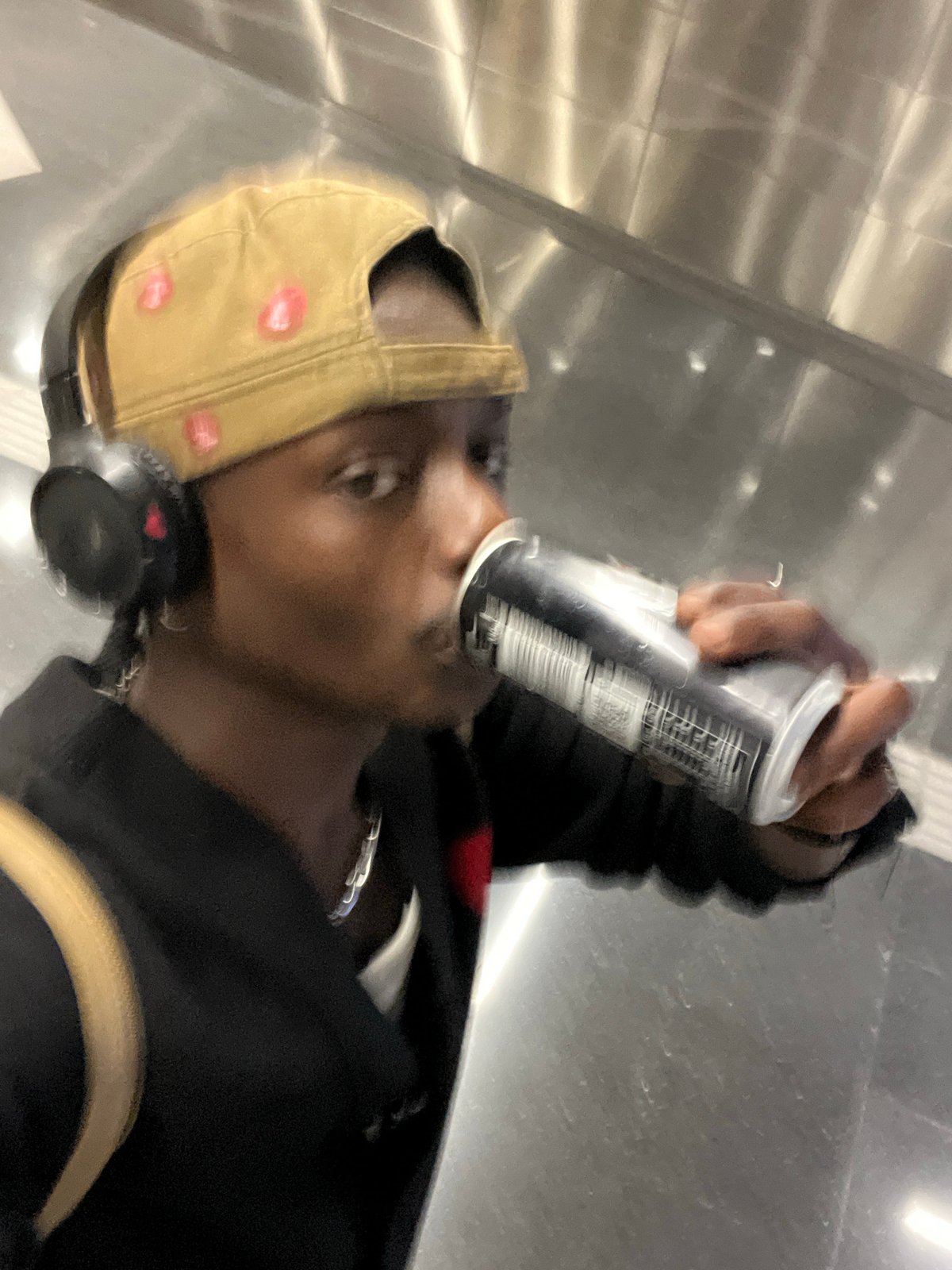 Person photographed drinking from can in Barcelona