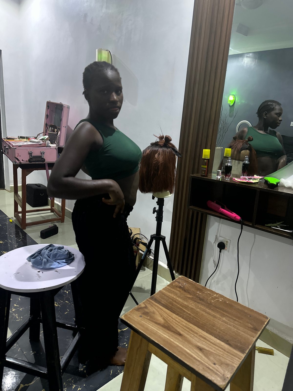 Wig styling and content creation setup in a Nigerian home studio