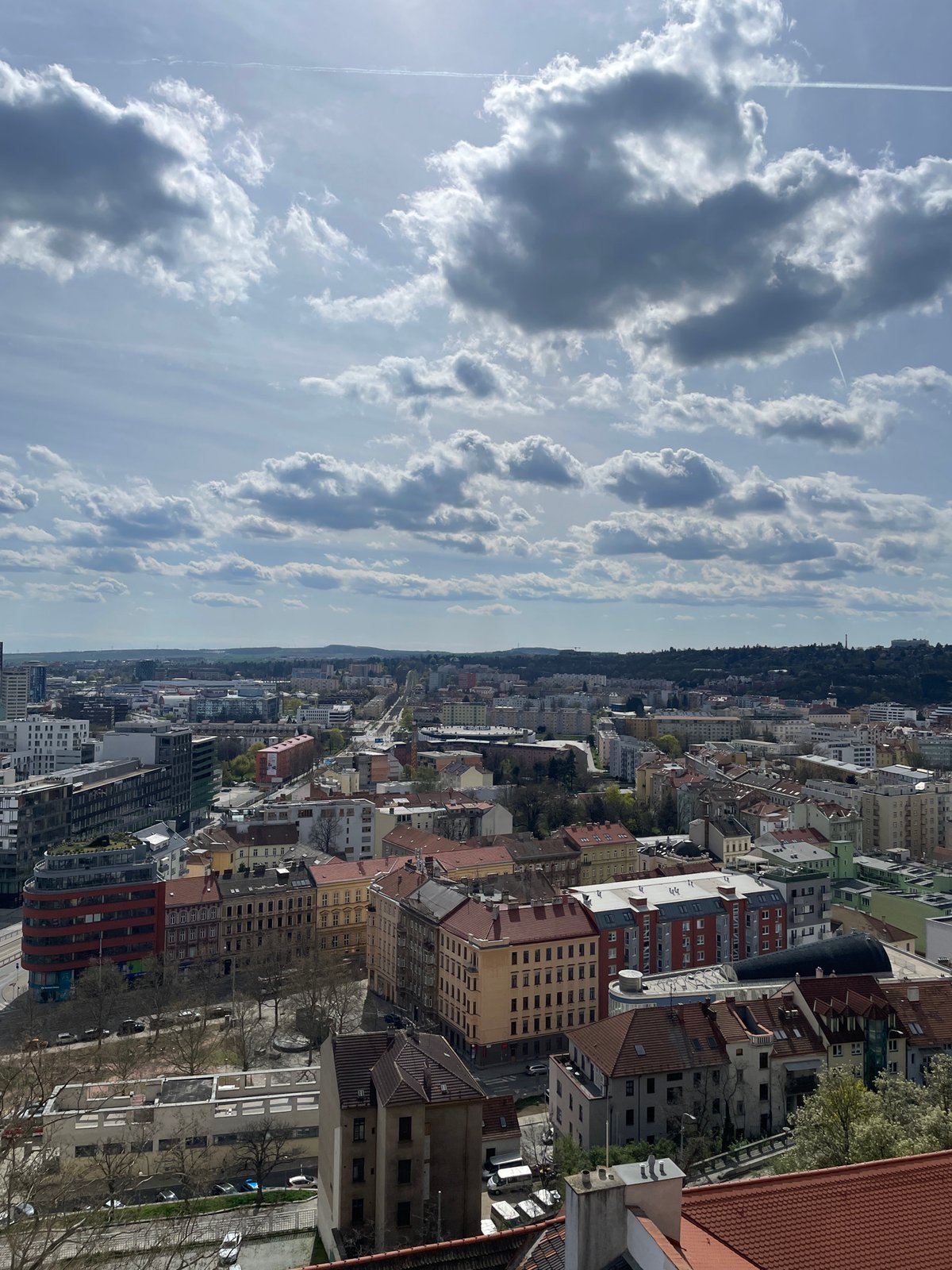 Aerial view captures Brno cityscape under cloudy skies
