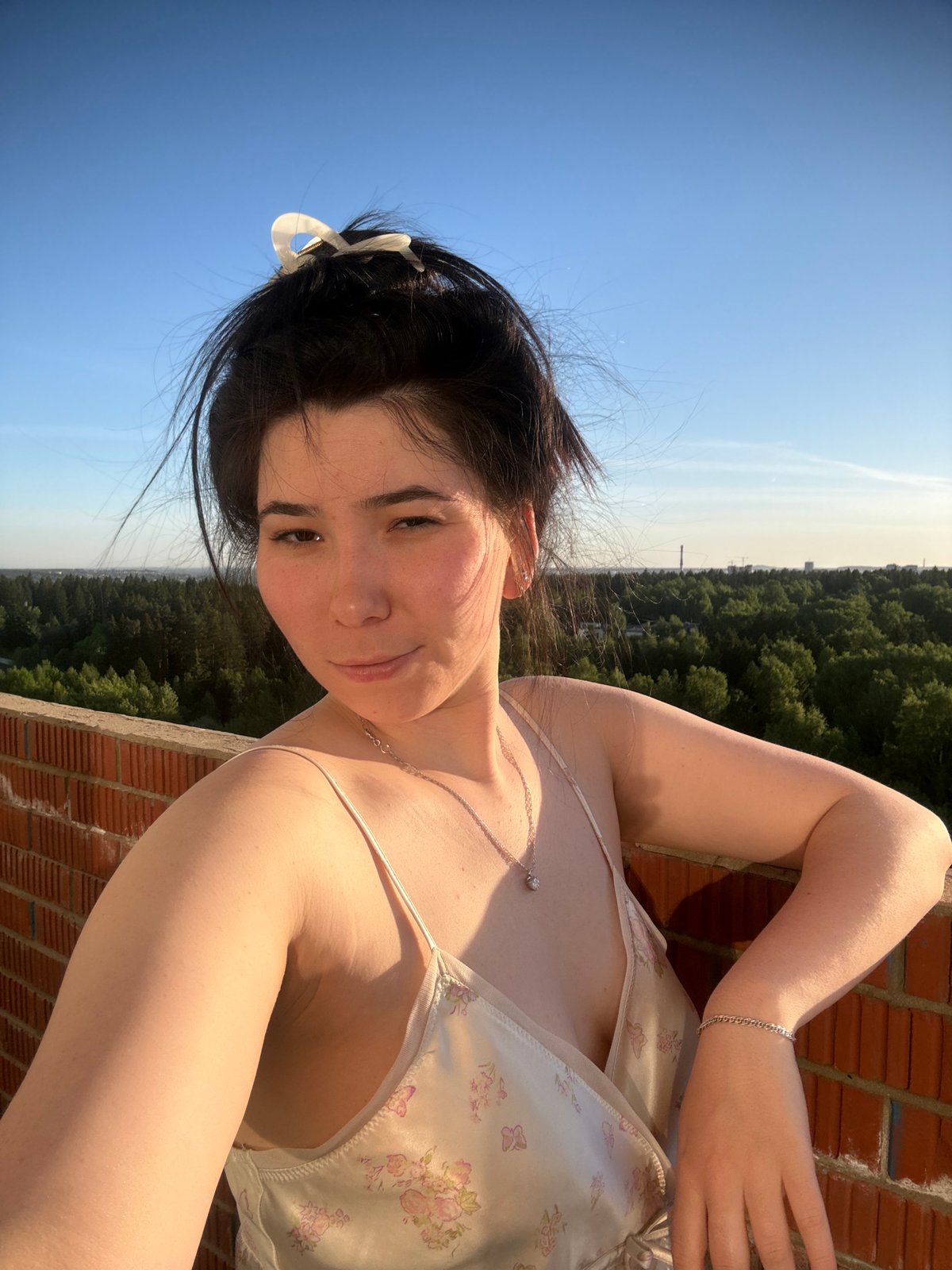 Woman documents afternoon in Izhevsk with selfies and cityscape photos